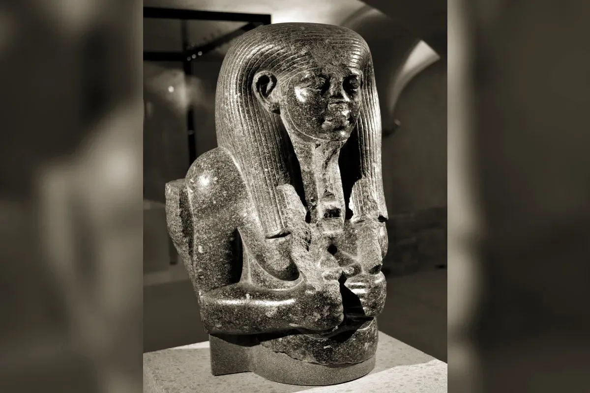 Upper part of a granite statue of Hapi, god of the Nile flood