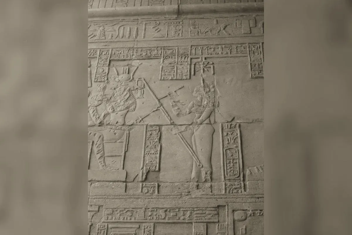 Egyptian wall relief of Seshat recording the annals, palm rib in hand